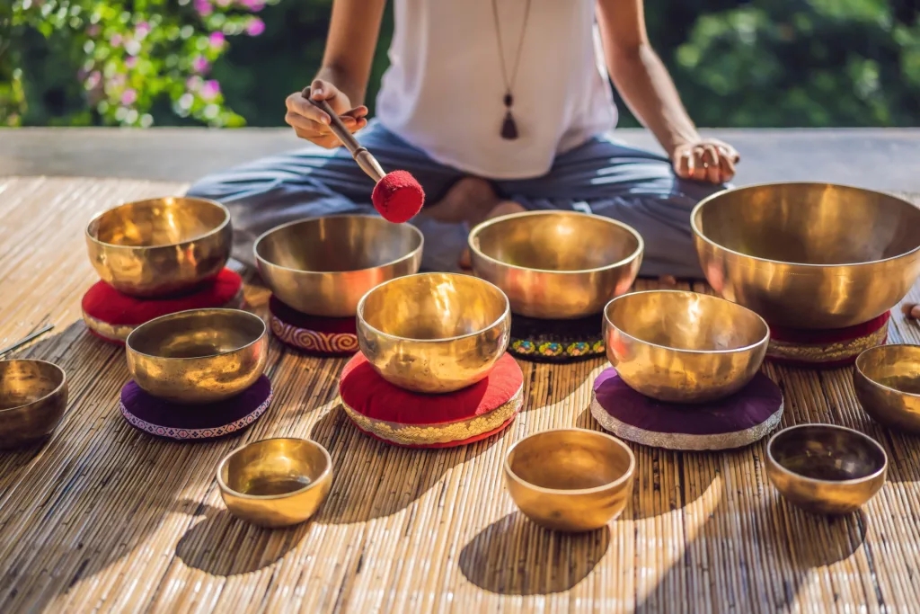 woman playing tibetan singing bowls